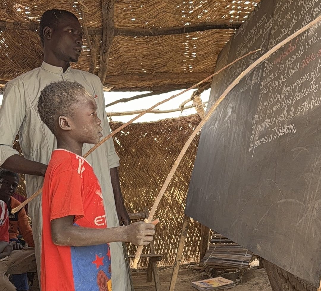A pupil at the blackboard in a straw classroom in Chad