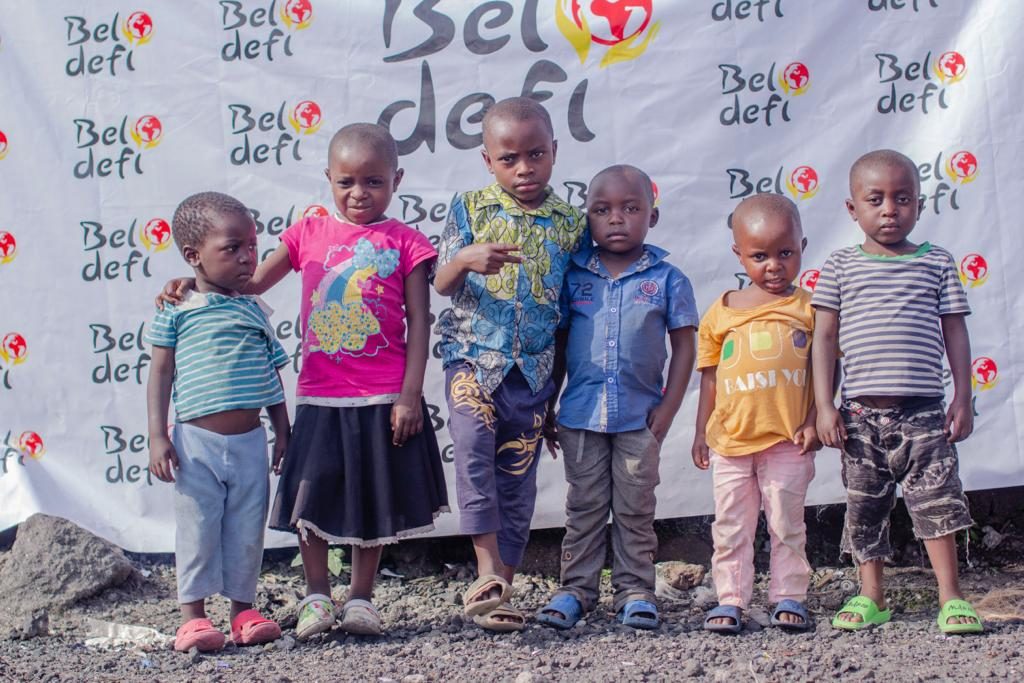 Children in front of the Beldefi banner